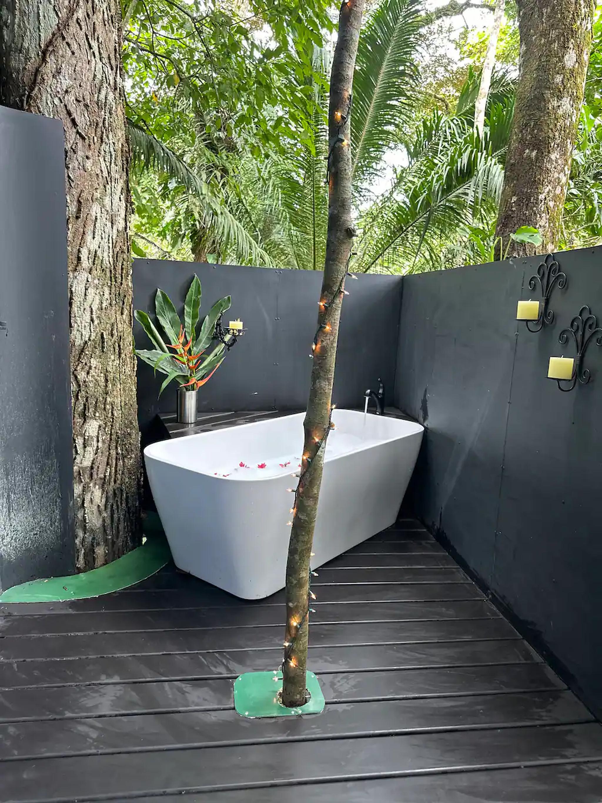 Open-air tropical bathtub with jungle views and spa-like serenity