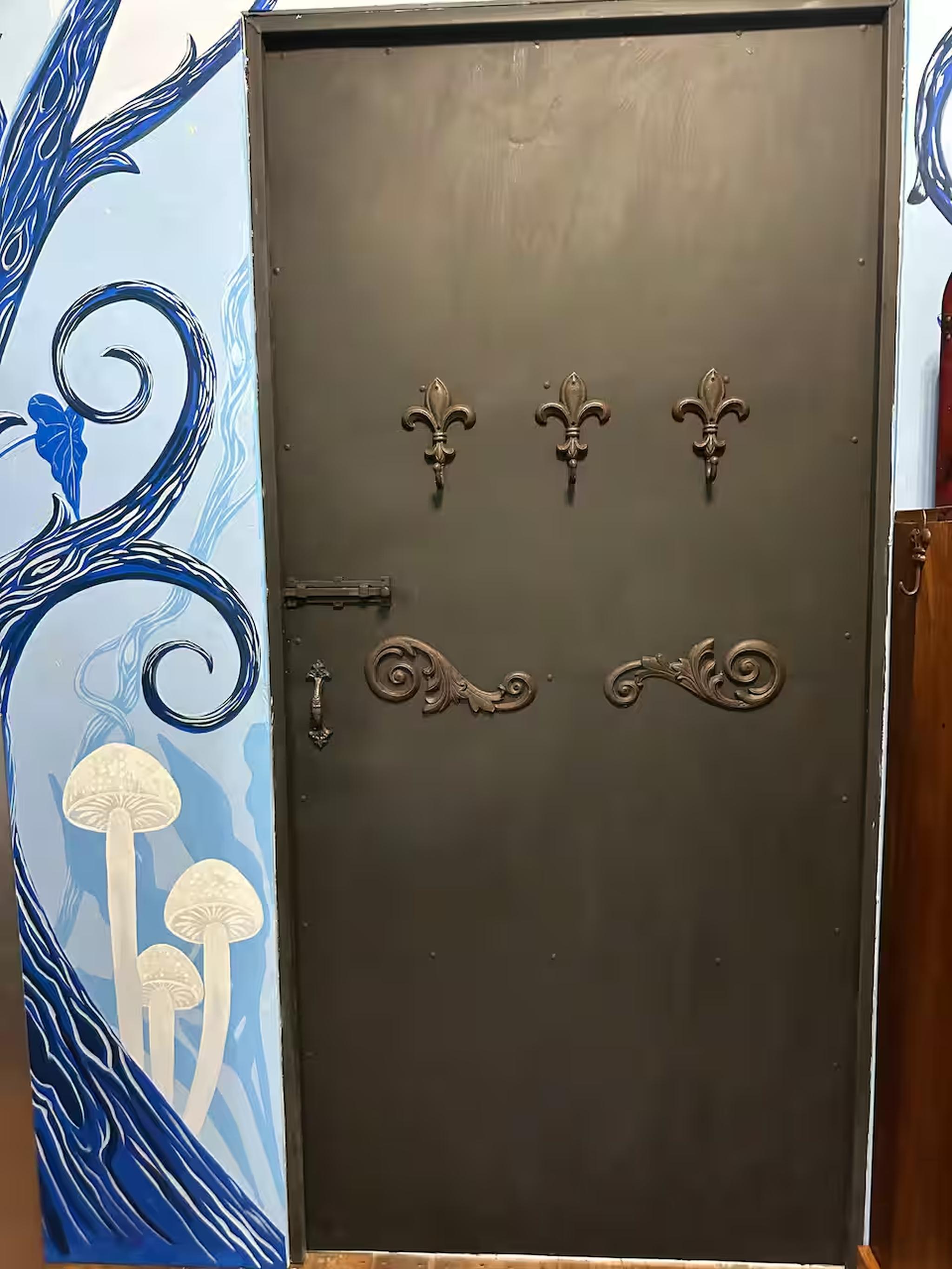 Whimsical mural entry with ornate door and artistic charm