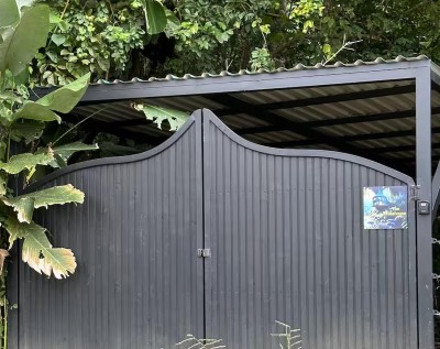 Private gated entrance surrounded by lush tropical greenery