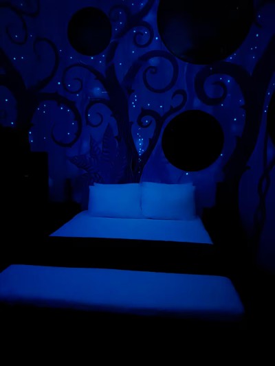 Whimsical glow-in-the-dark bedroom with dreamy, immersive ambiance