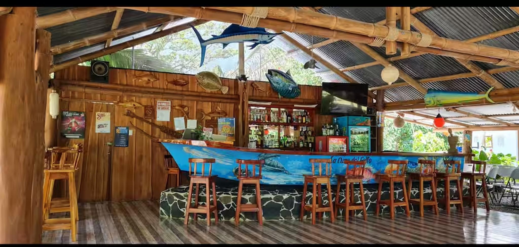 Open-air tropical bar with a unique boat bar and relaxed island vibes