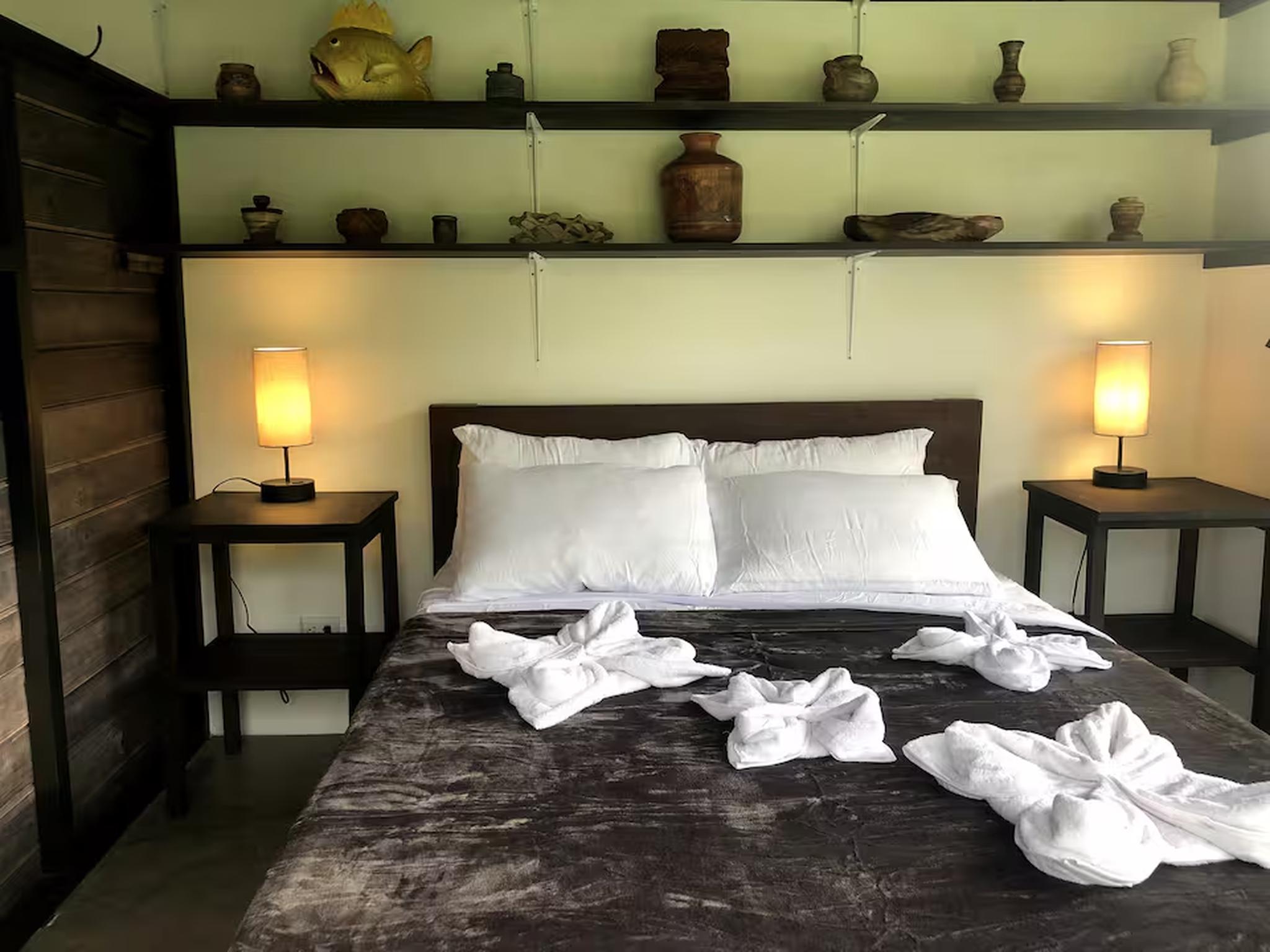 Cozy bedroom with warm lighting, rustic decor, and a stylish king bed