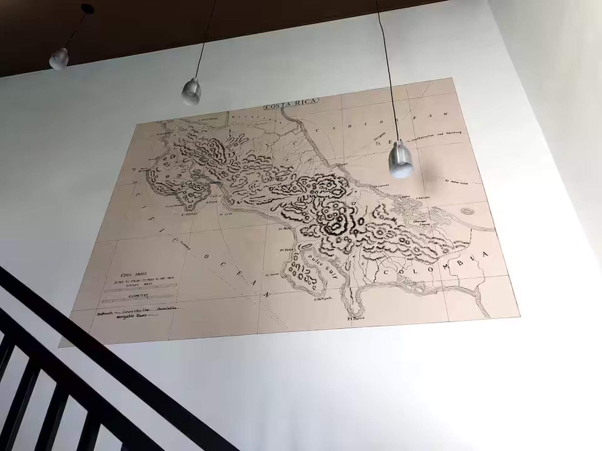 Statement stairway wall with oversized vintage Costa Rica map