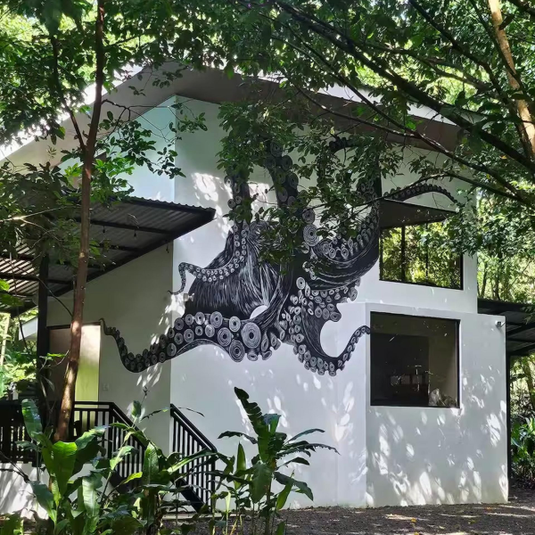 Jungle hideaway with bold octopus mural and modern villa design