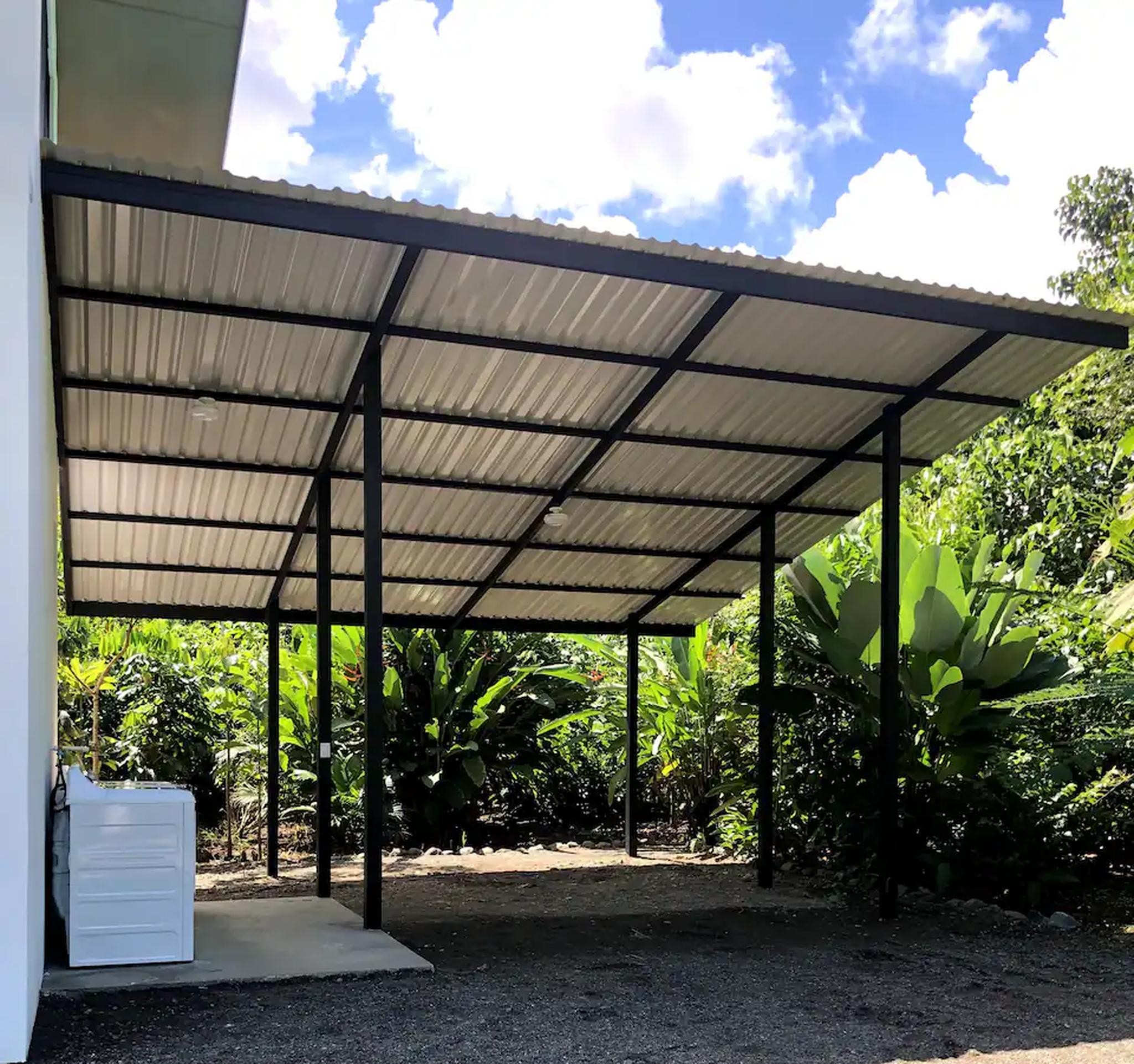 Spacious covered parking surrounded by lush tropical greenery
