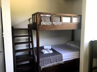 Cozy built-in bunk nook with dark wood accents—ideal for families or friends