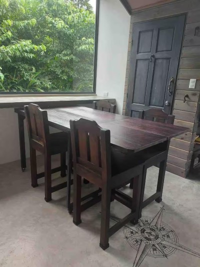 Rustic dining nook with lush jungle views and beautiful natural light