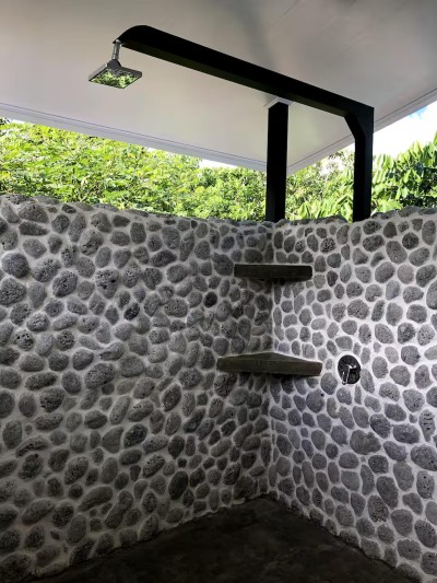 Private open-air stone shower with tropical, spa-like ambiance
