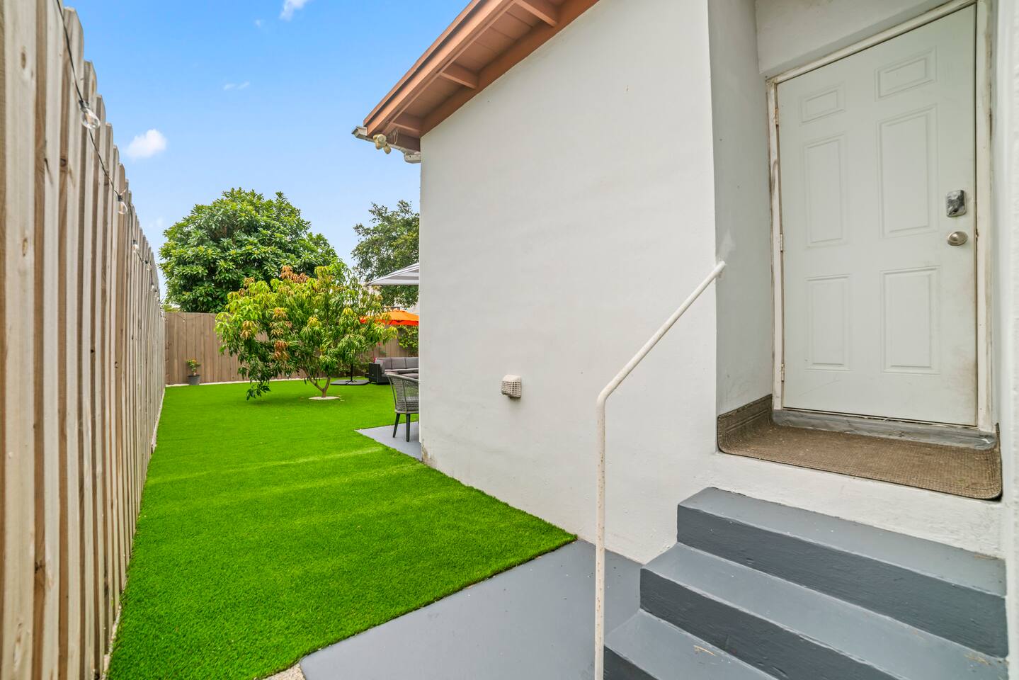A true backyard retreat, complete with cozy lounge seating, outdoor dining, and plenty of open space to enjoy the outdoors.