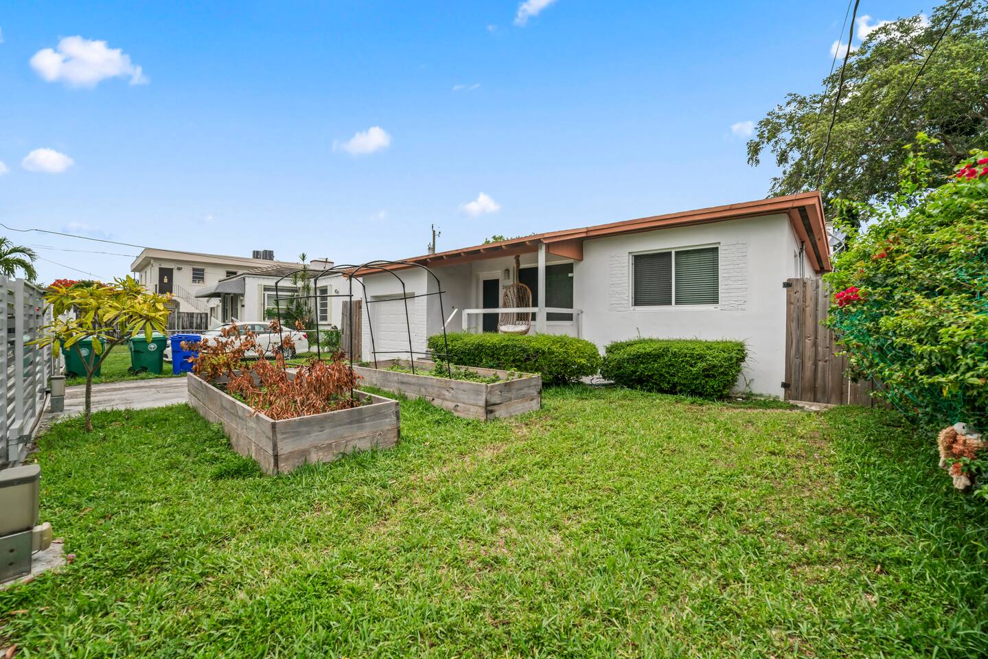 Thoughtfully landscaped and designed for easy living, this property features a welcoming porch, garden beds, and a large yard with room to relax and play.