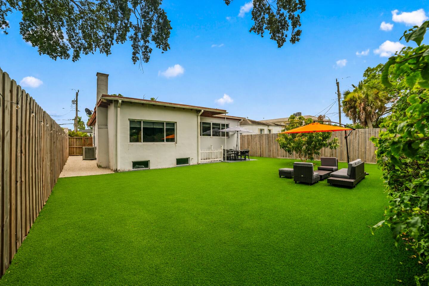 The spacious backyard provides a private outdoor retreat, complete with comfortable seating and plenty of room to relax, gather with family and friends, or enjoy the sunshine.