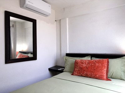 Cozy air-conditioned bedroom with stylish accents and a bright, clean feel