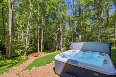 Private hot tub and fire pit nestled in a peaceful wooded setting — the perfect combination for unwinding, stargazing, and soaking in the magic of a mountain evening.