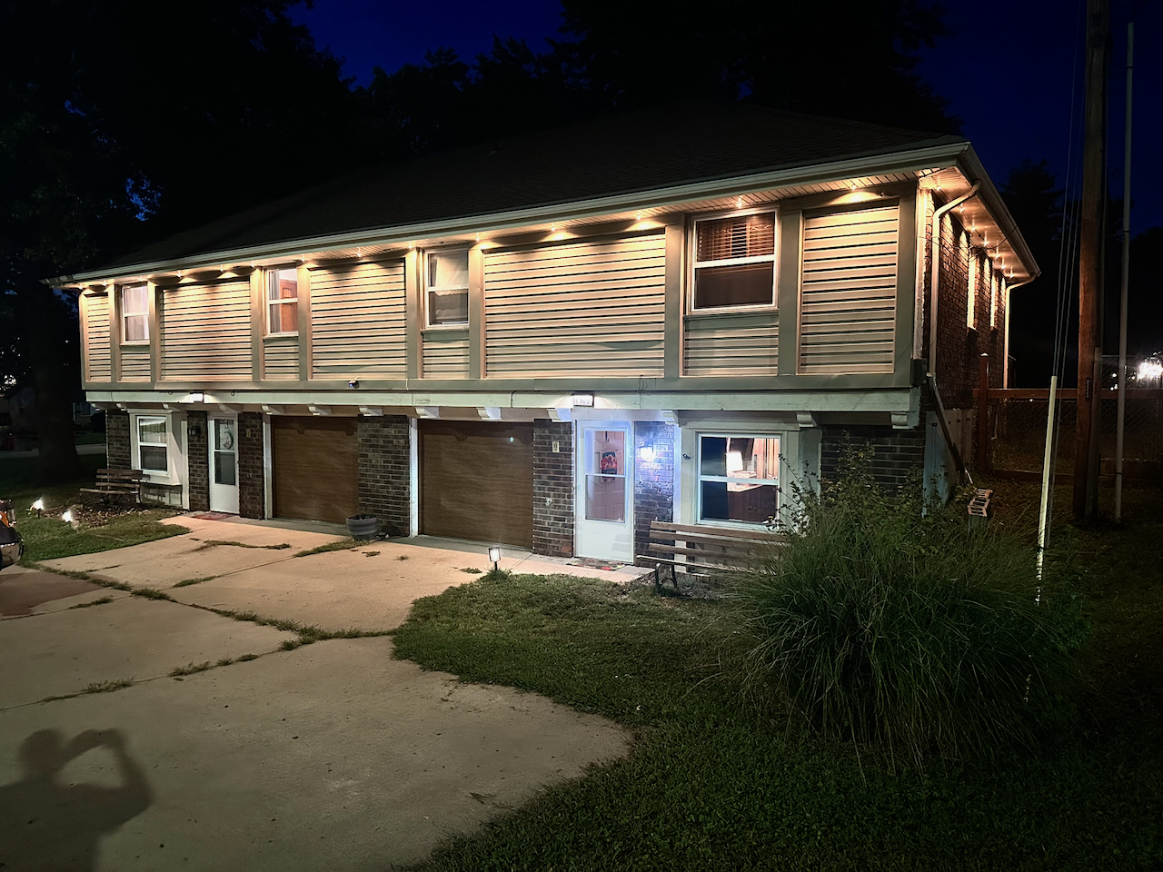 Well-lit exterior with spacious driveway and private entry