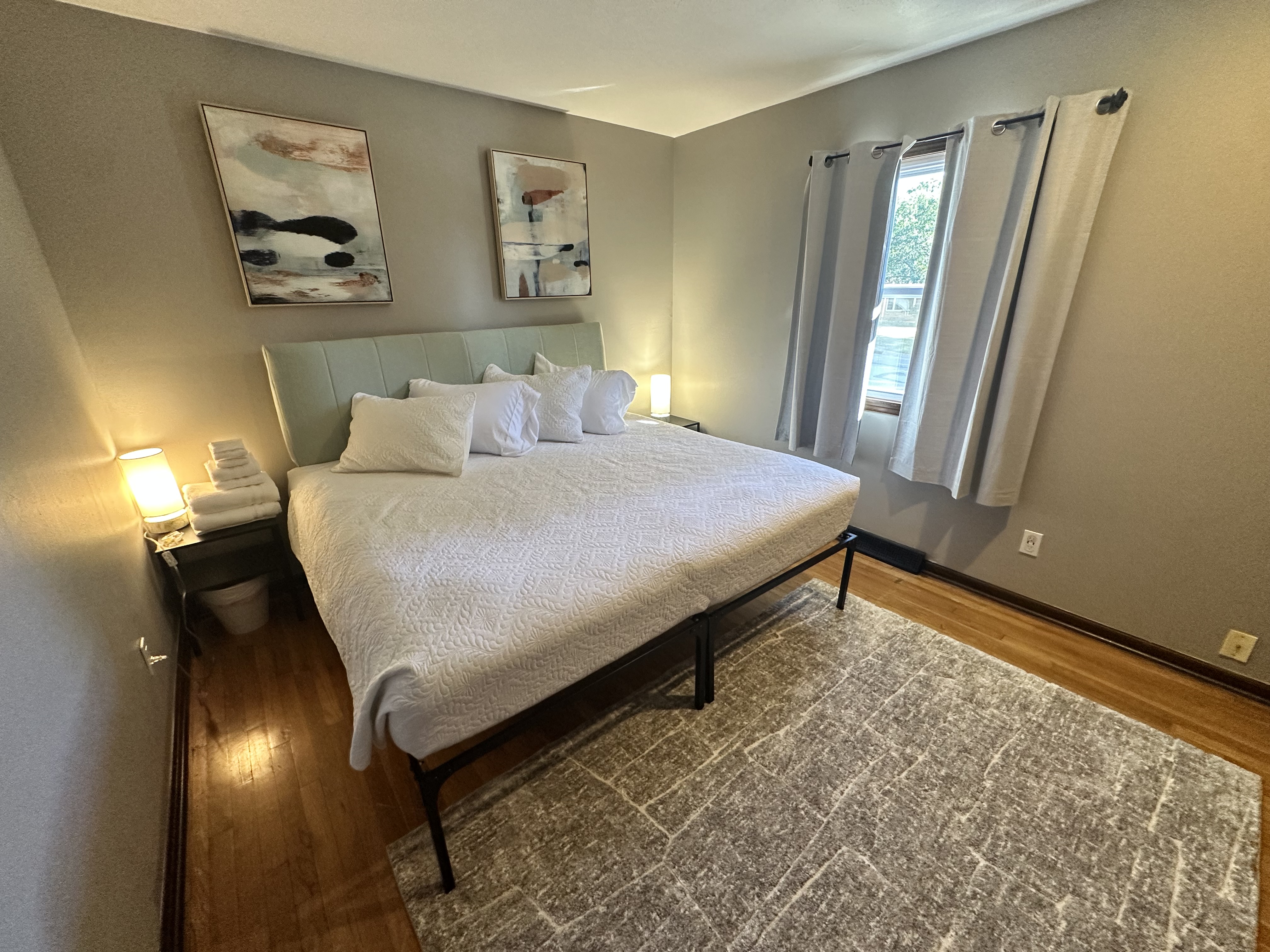 Bright, cozy bedroom with plush king bed and soothing modern decor