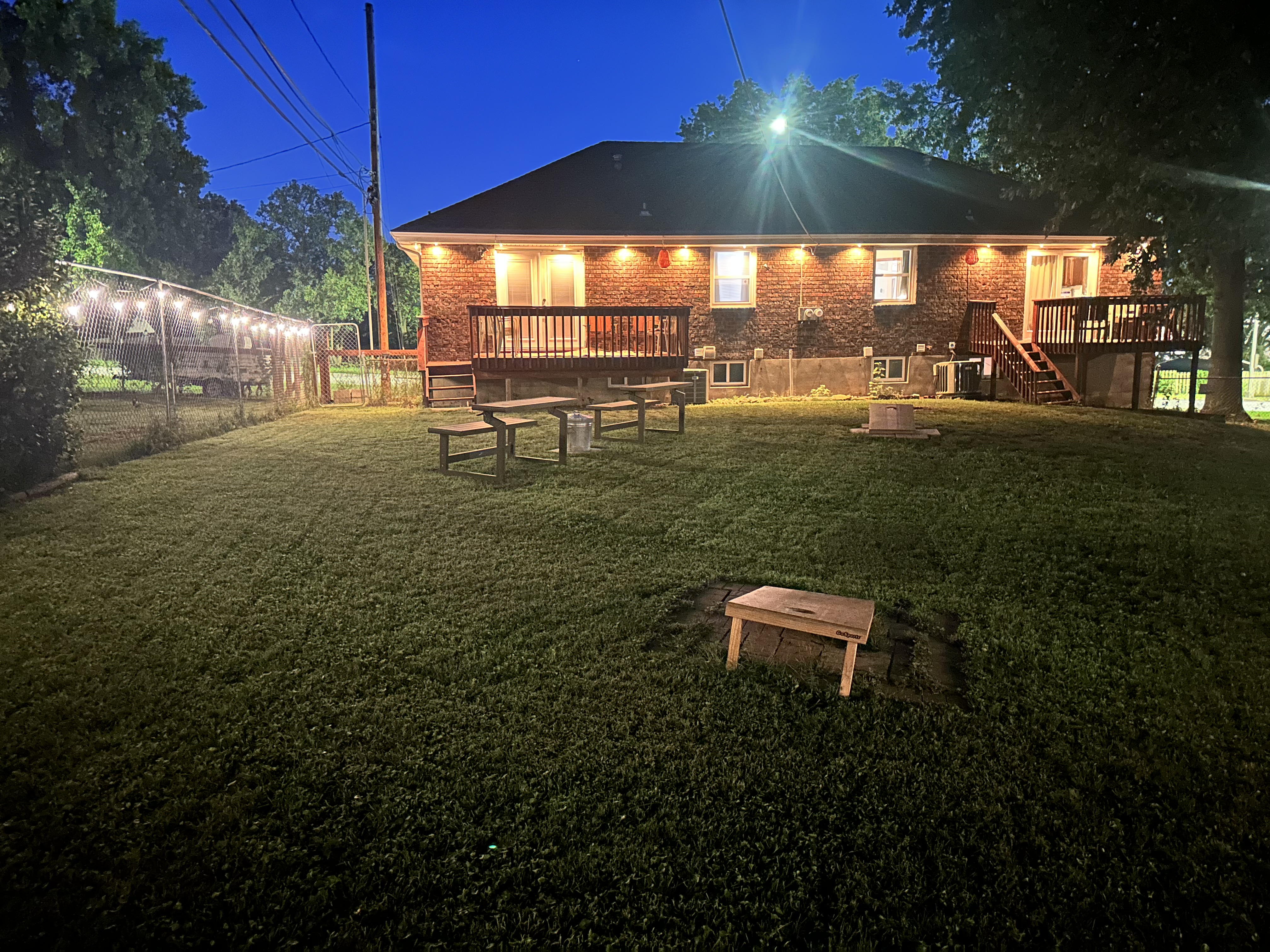 Spacious, well-lit backyard with deck and games for relaxing nights
