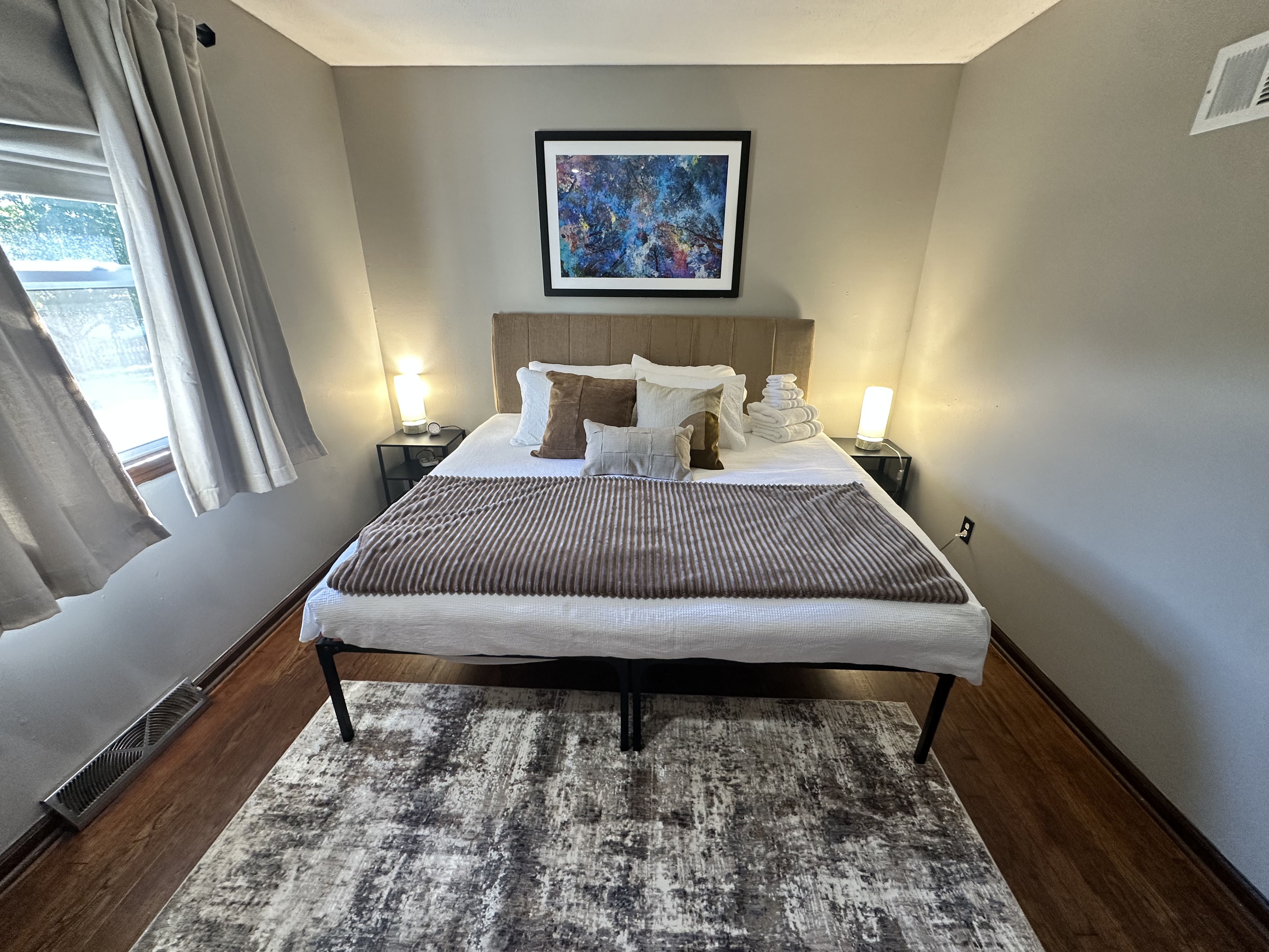 Cozy modern bedroom with soft lighting and plush king bed