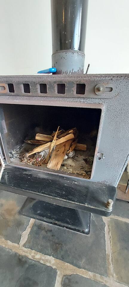 The wood fireplace at The Deck, Crescent Head — a cosy spot on a rainy day