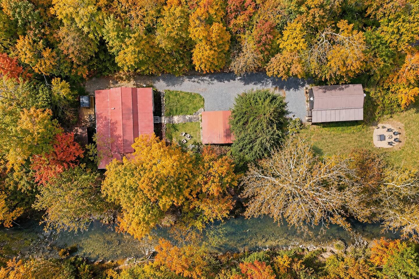 There is another cabin located on the property which you’ll see as you go down the driveway. It’s separated by a large pine tree and carport (middle red roof is carport) which offers privacy to both cabins (your cabin is to the left in the photo).