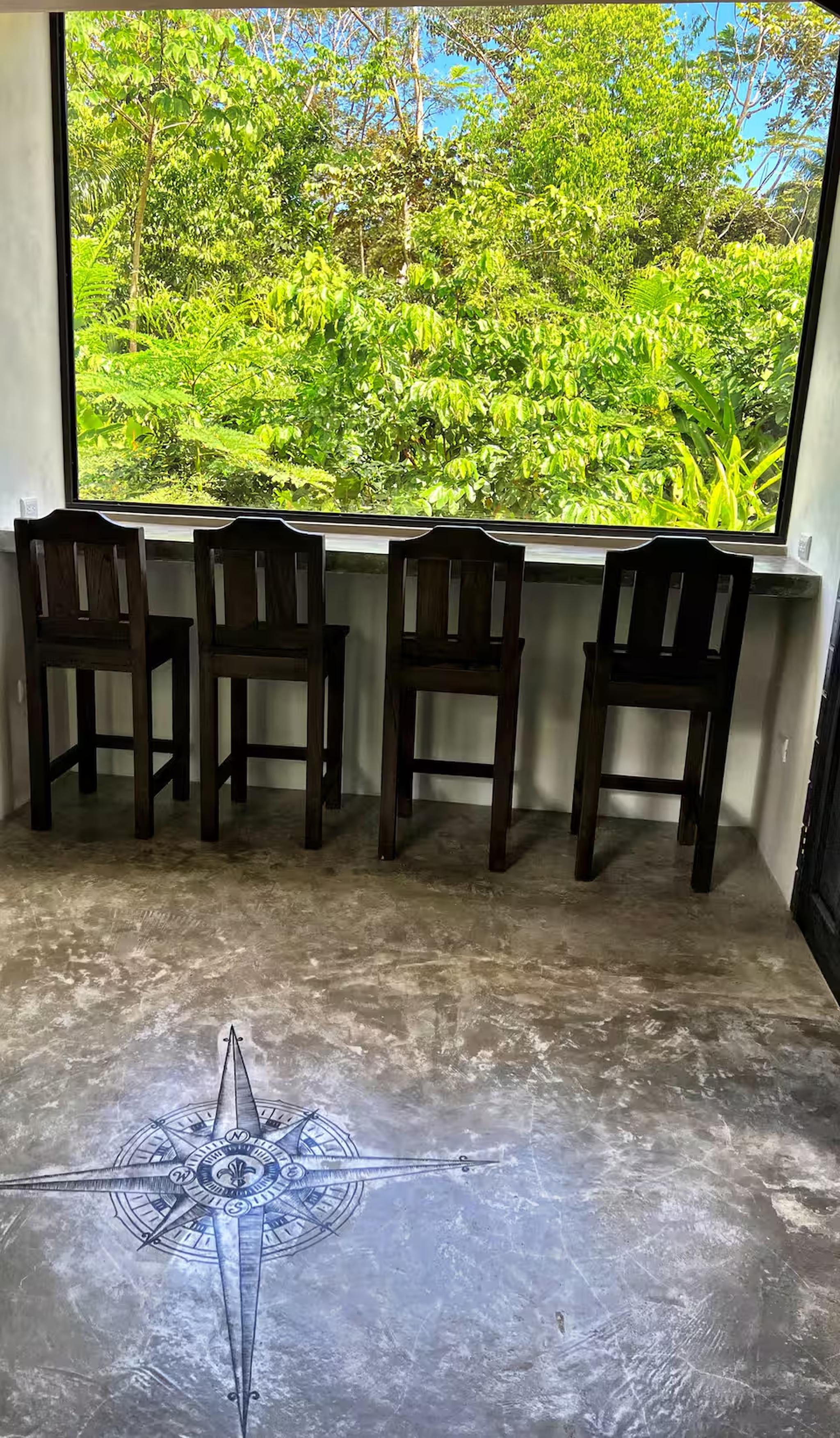 Window bar seating with lush jungle views for coffee, work, or relaxing