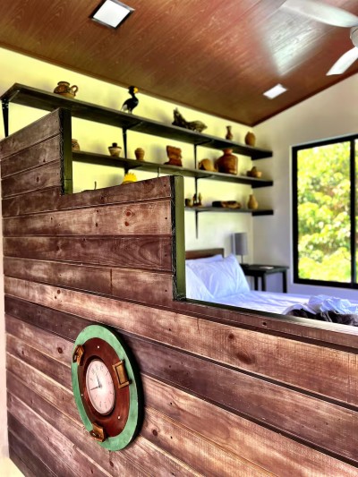 Unique ship-inspired bedroom with warm wood accents and garden views