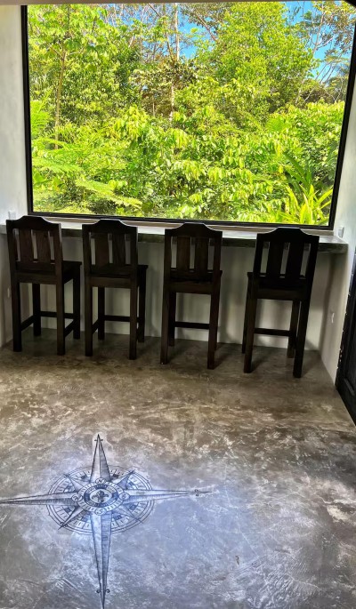 Window bar seating with lush jungle views for coffee, work, or relaxing