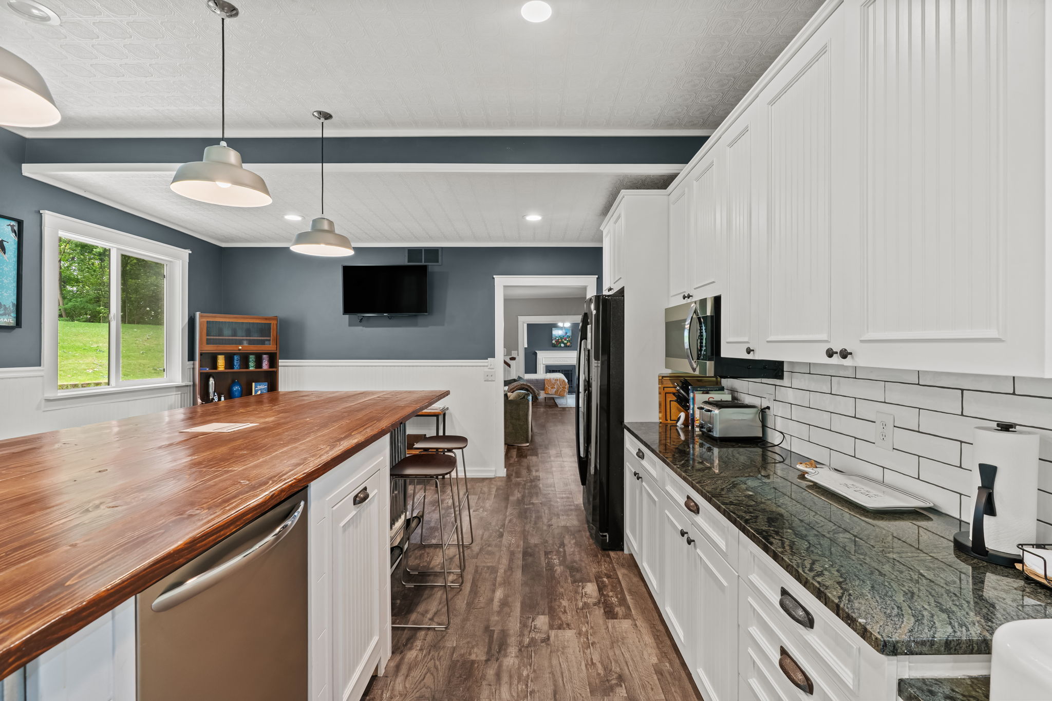 Spacious modern kitchen with oversized island, bar seating, and bright natural light
