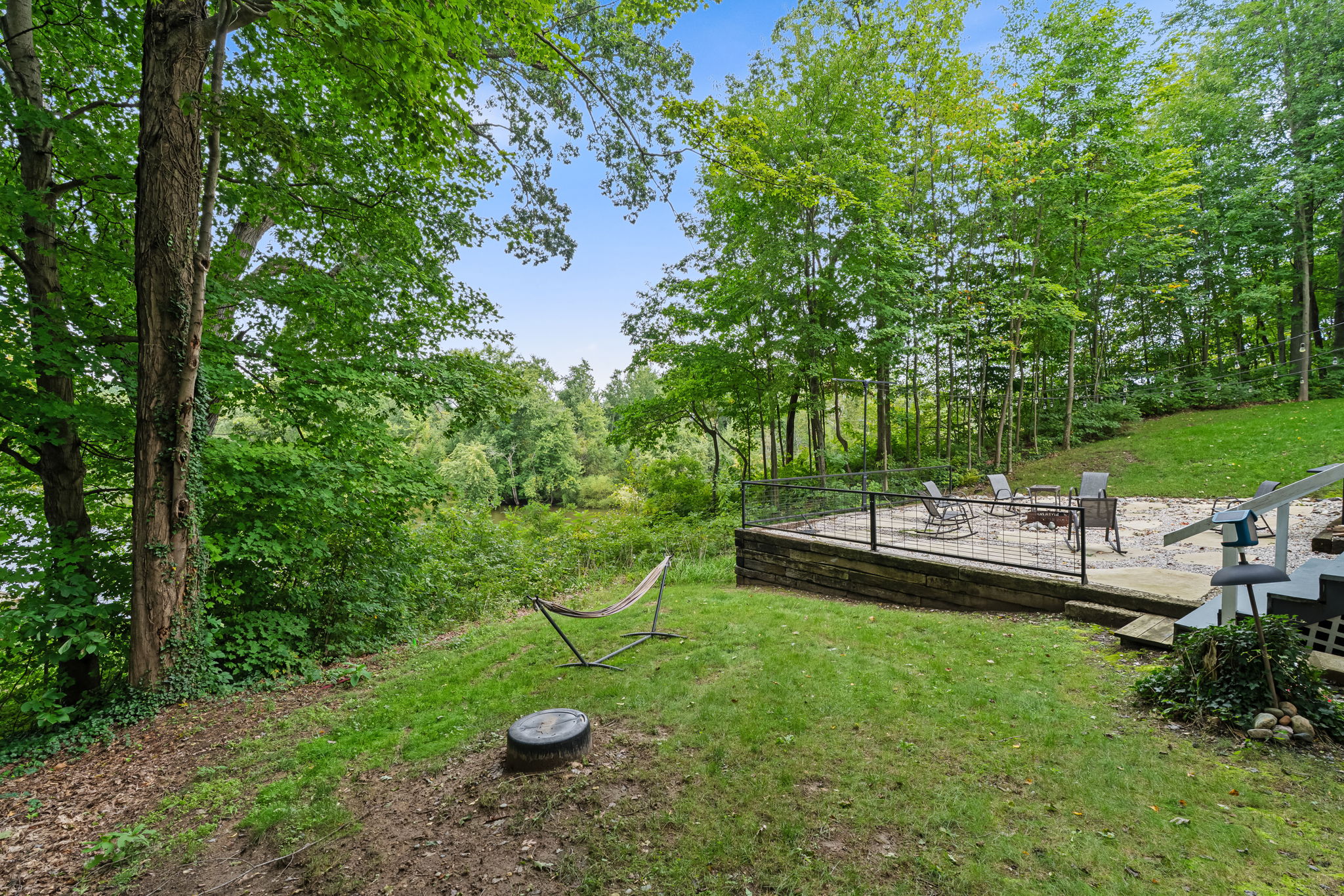 Private wooded backyard with patio seating and peaceful nature views