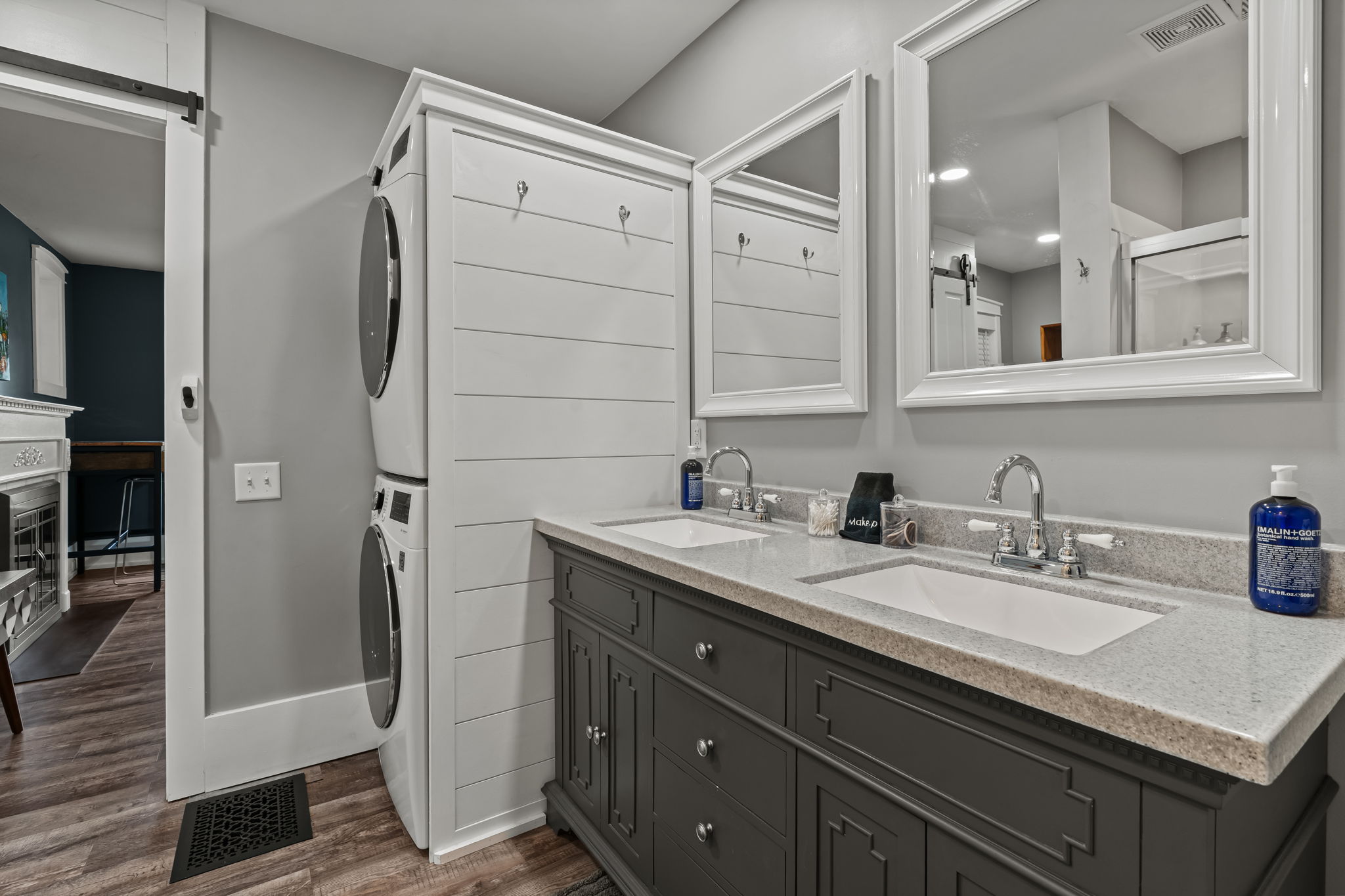 Modern double vanity bath with in-unit washer/dryer convenience