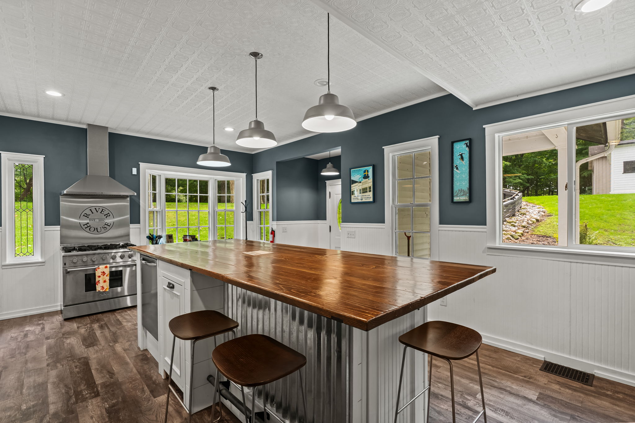 Bright farmhouse kitchen with oversized island and scenic natural light
