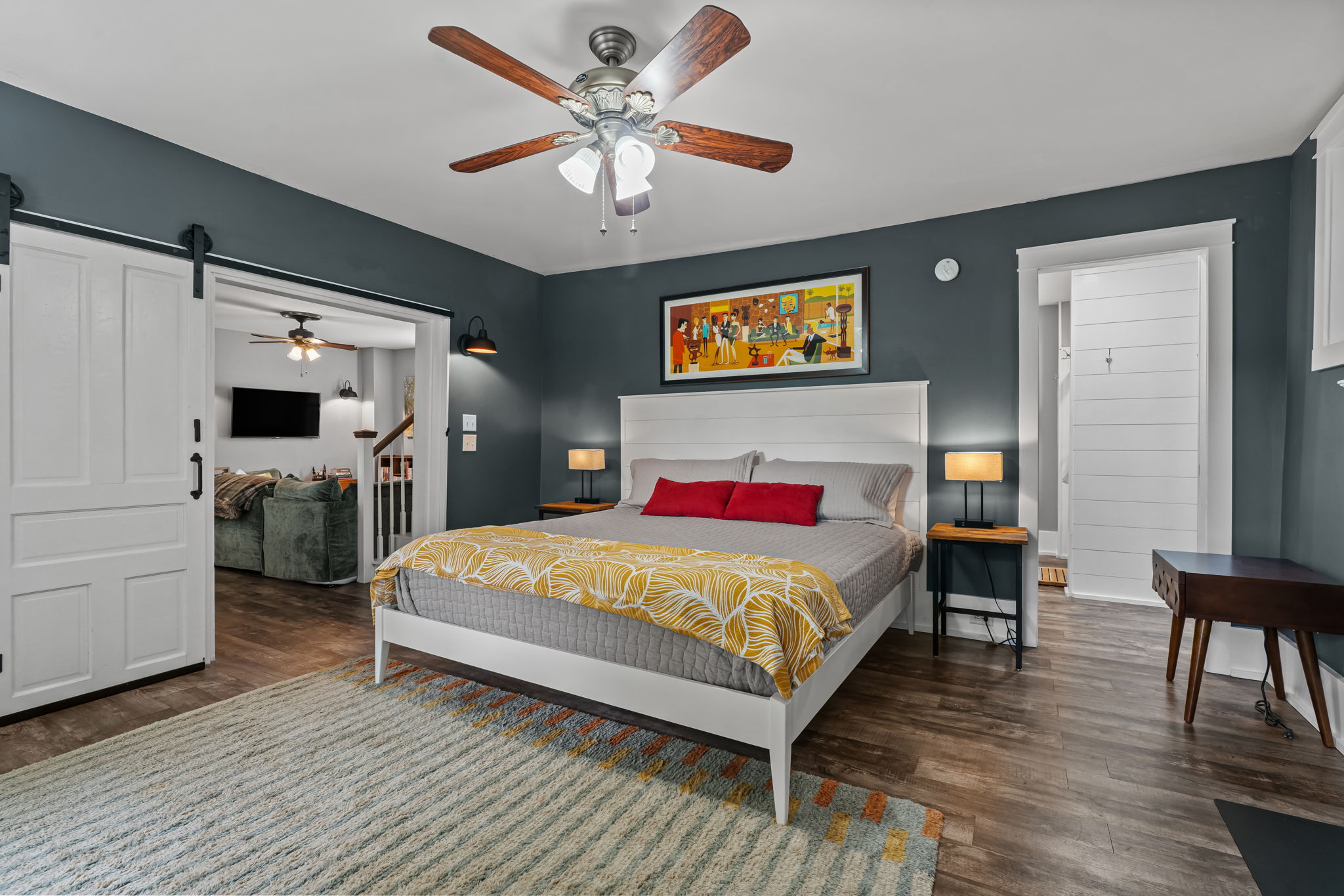 Spacious, stylish bedroom with barn doors and cozy modern touches