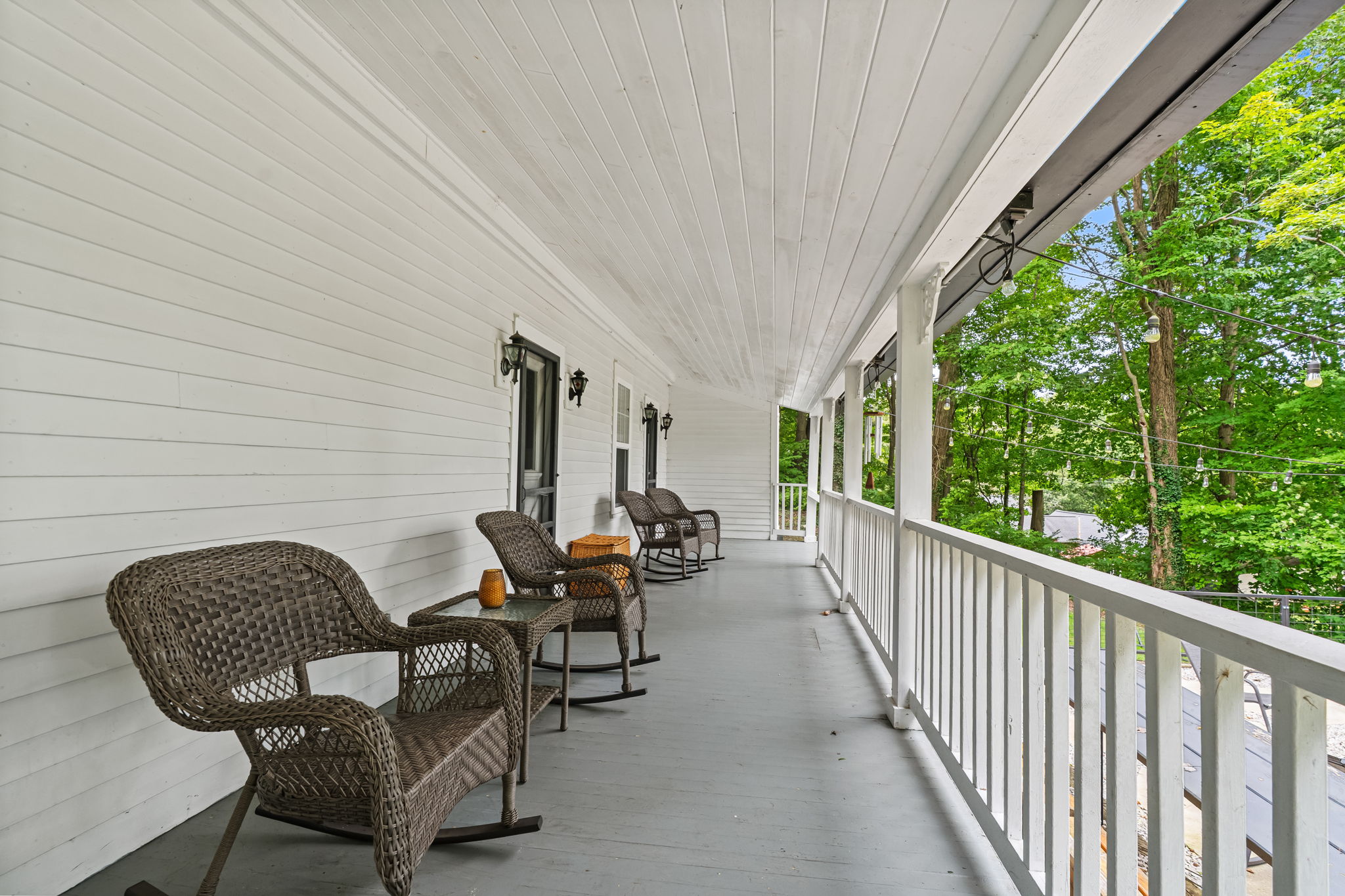 Relax on the shaded porch with rocking chairs and peaceful tree views