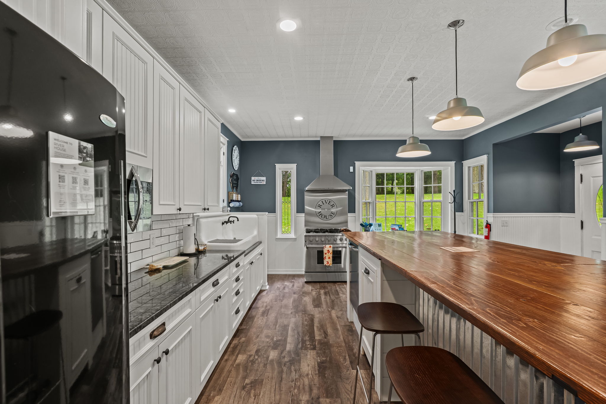 Spacious gourmet kitchen with oversized island, bar seating, and bright views
