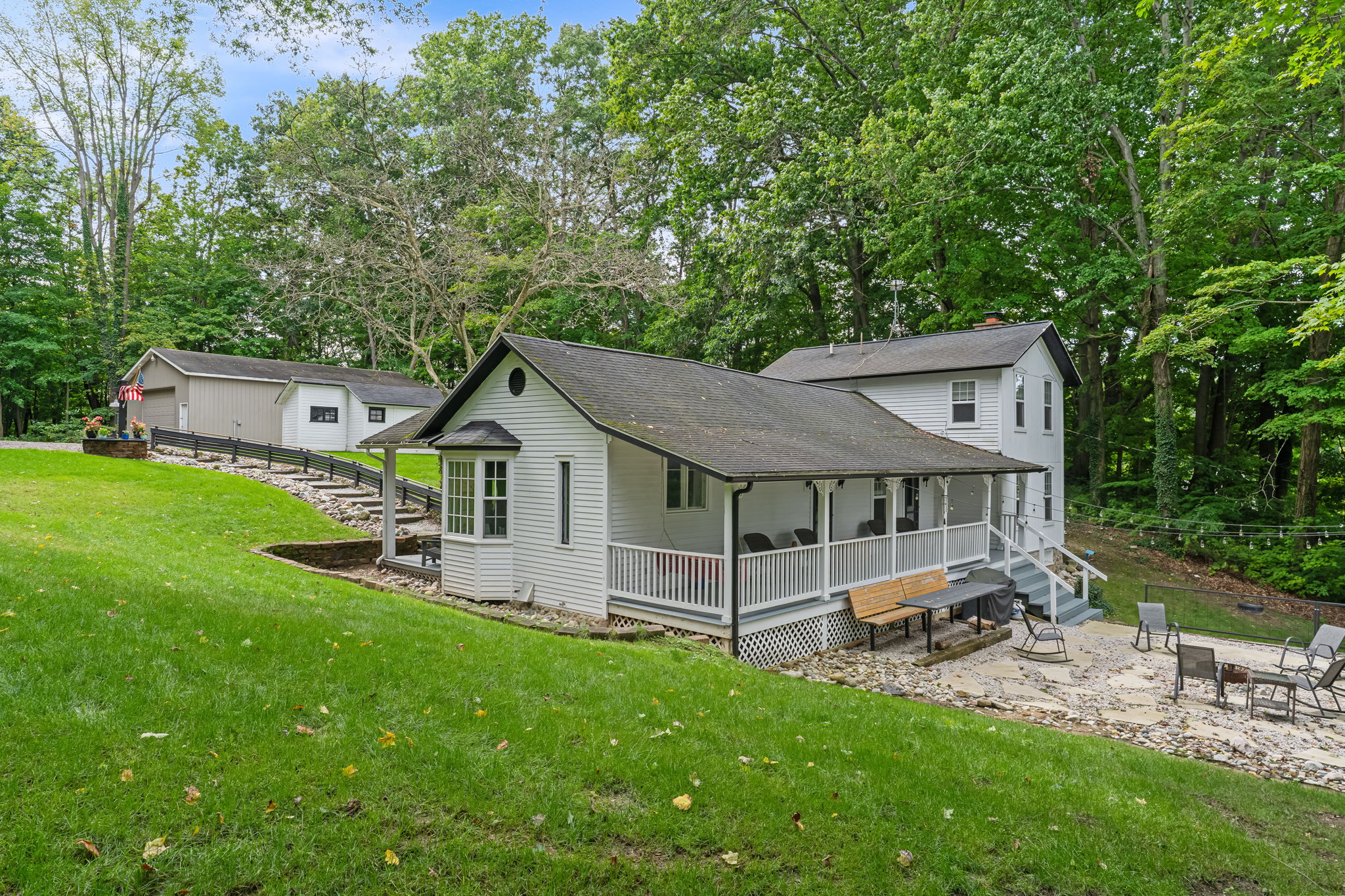 Peaceful woodland cottage with wraparound porch and fire pit patio