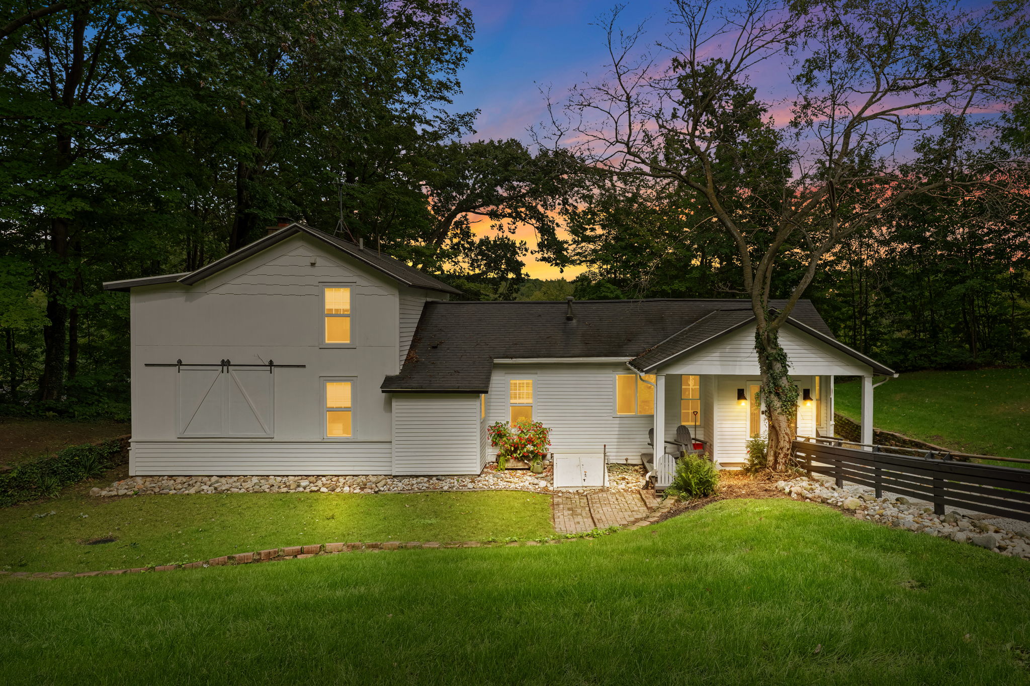 Charming woodland retreat with a cozy porch and glowing evening ambiance