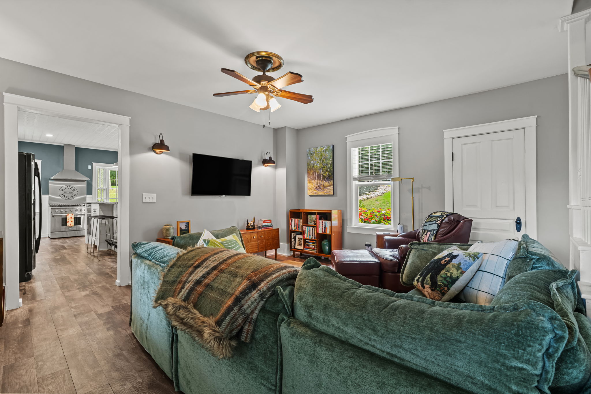 Cozy living room with plush sectional, TV, and bright open layout