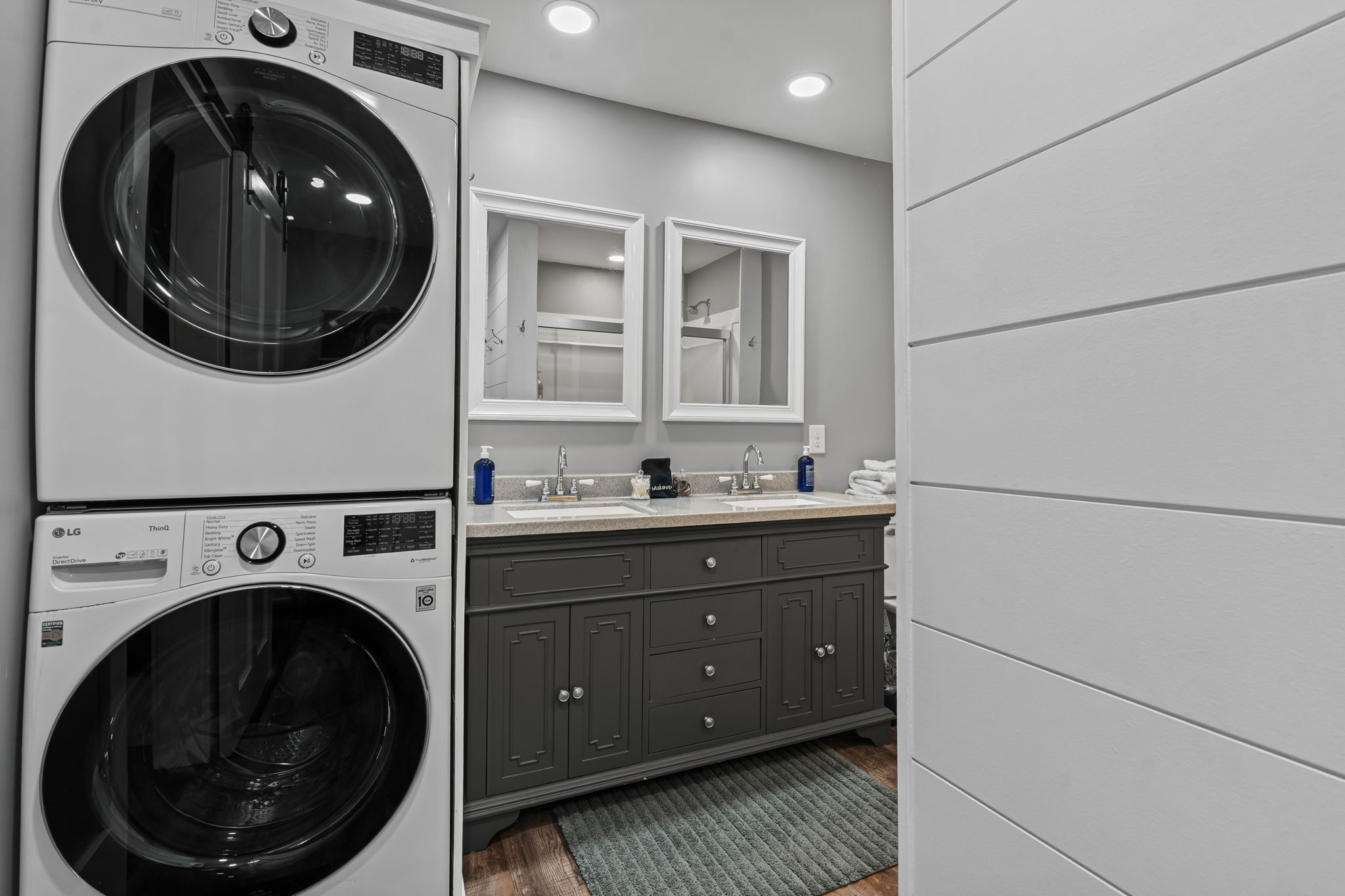 Modern double-vanity bath with in-unit washer and dryer