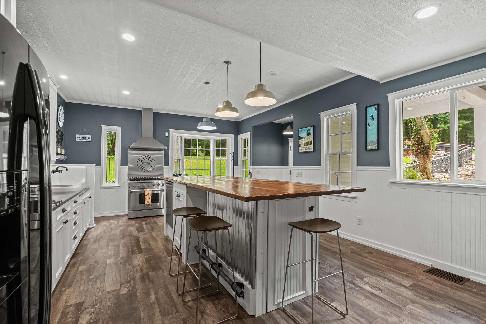 Spacious modern kitchen with large island, bar seating, and bright natural light