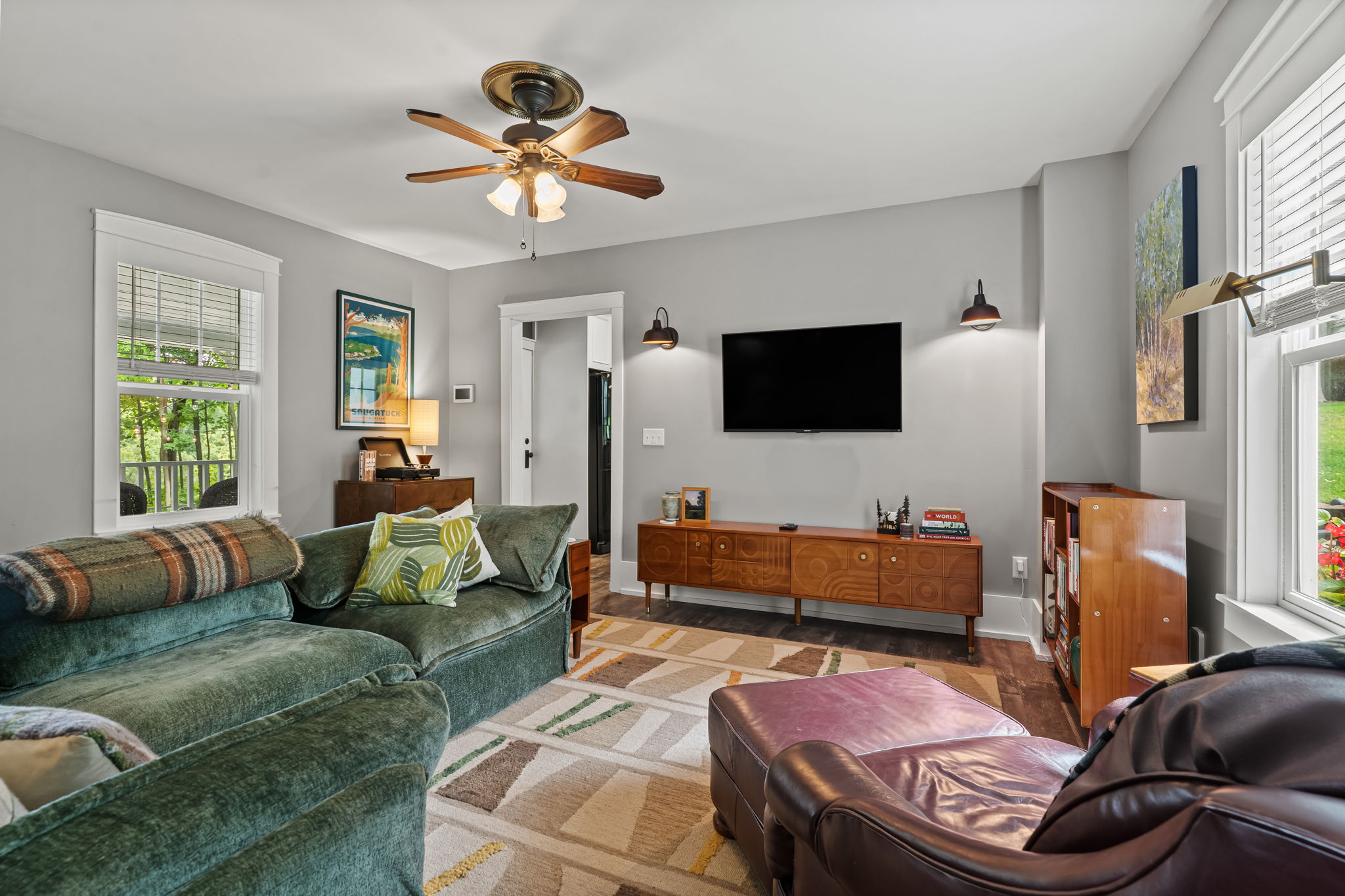 Bright, cozy living room with plush seating and a large smart TV