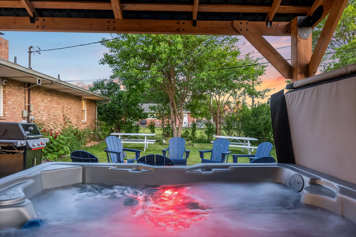 Hot tub glowing at dusk under the covered patio