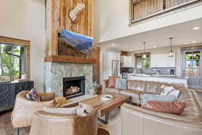The living room offers a warm, inviting space to unwind, featuring comfortable seating and a cozy atmosphere perfect for relaxing after a day in the mountains.