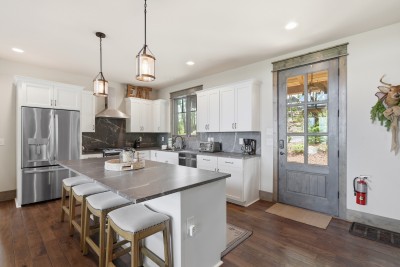 Bright modern kitchen with a large island for seating, sleek finishes, and an open layout that flows effortlessly into the living space — perfect for cooking, gathering, and connecting.