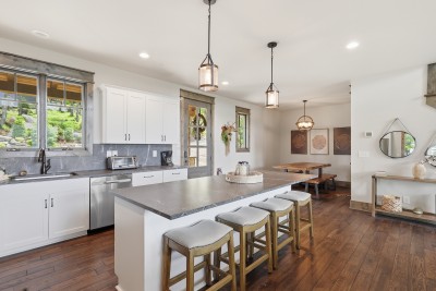 Bright open kitchen featuring a large island for seating and a cozy dining nook — perfect for casual meals and easy conversation.