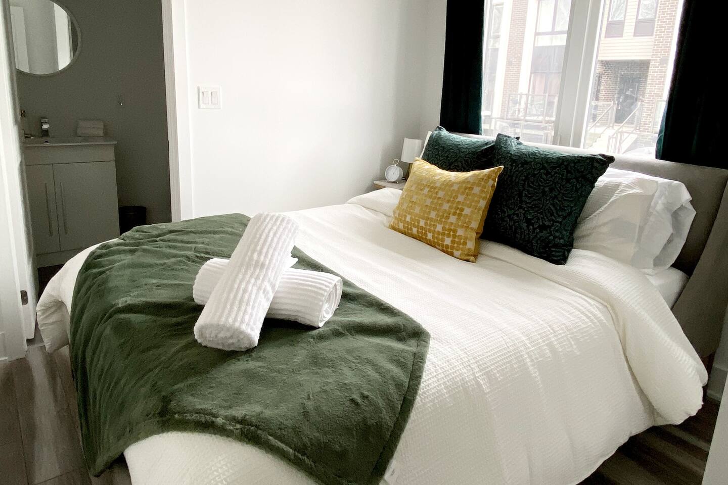 Comfortable bed with fresh linens, layered pillows, and soft accents, creating a calm space to rest after a day out.