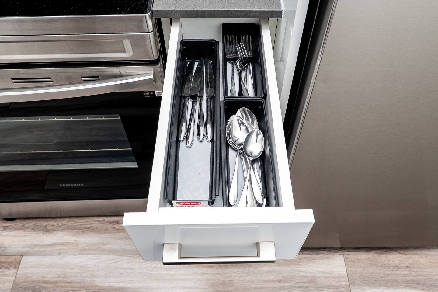 Kitchen drawer with neatly organized utensils and essentials, making meal prep and everyday dining more convenient during your stay.