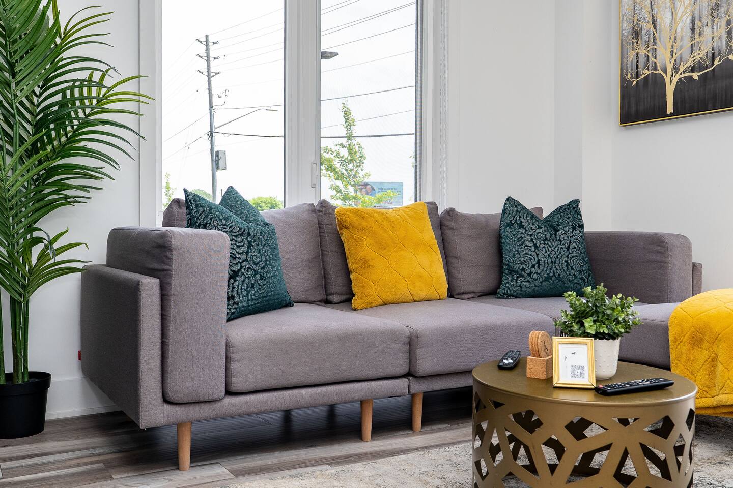 Comfortable living area with a soft sofa, colorful pillows, natural light, and stylish decor for relaxing after a day out.