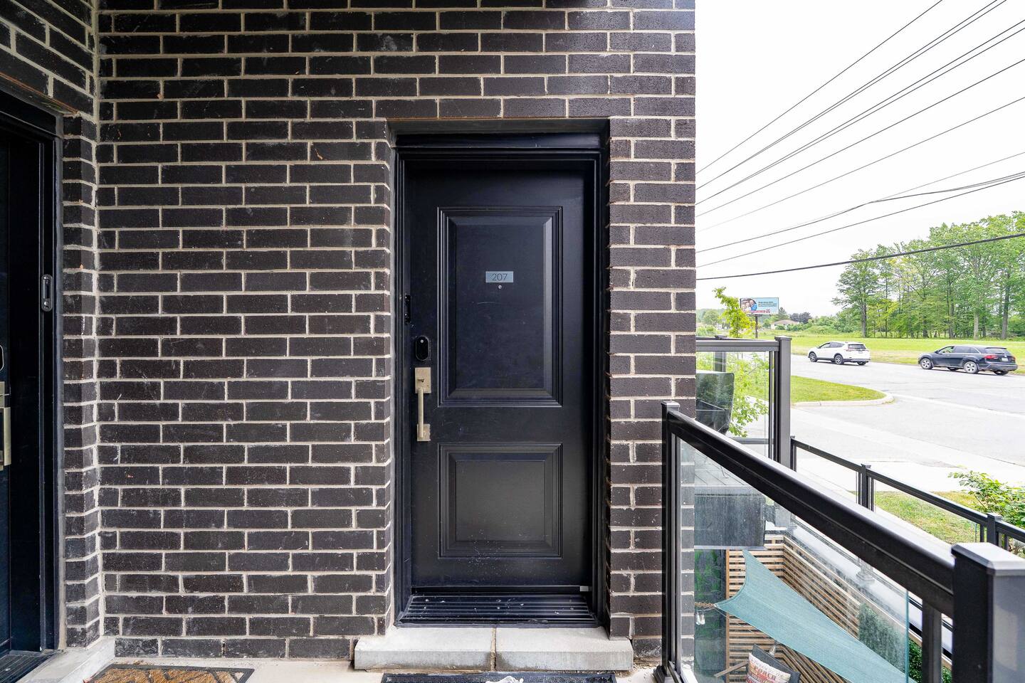 Private entry door with a covered exterior walkway and balcony access, providing a secure and convenient arrival experience.