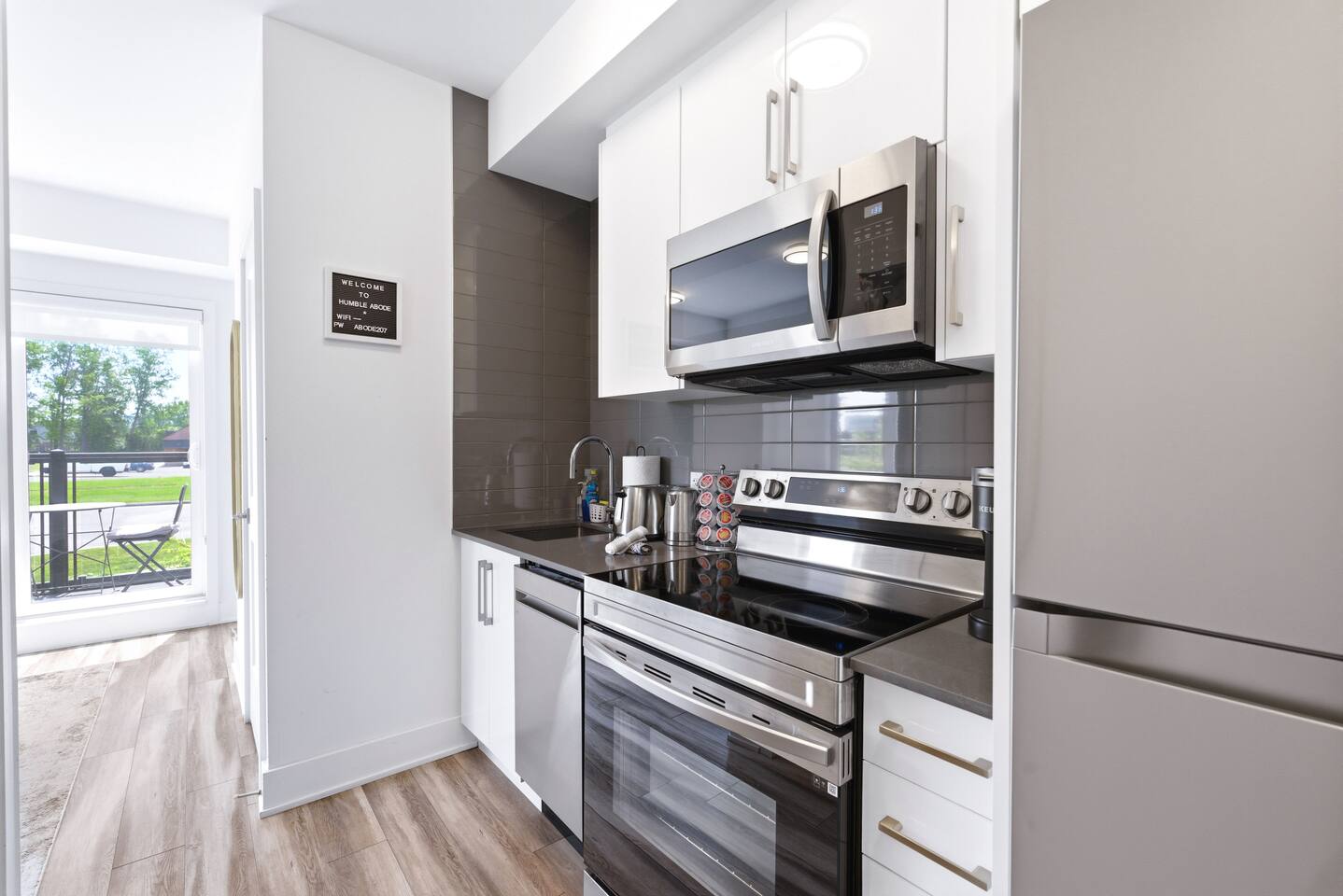 Compact kitchen with stainless appliances, sleek cabinetry, and coffee essentials, making meals and mornings easy during your stay.