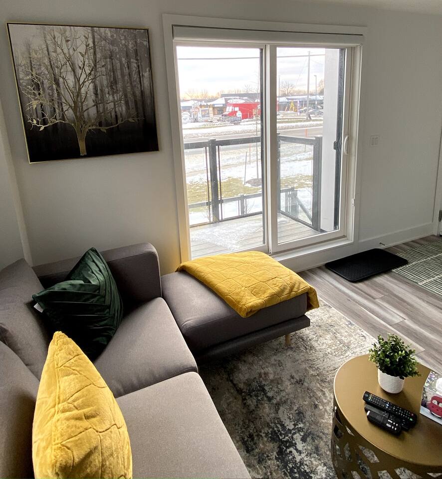 Patio facing street viewBright seating area with a chaise lounge, large balcony doors, and city views, creating a calm spot to unwind indoors.