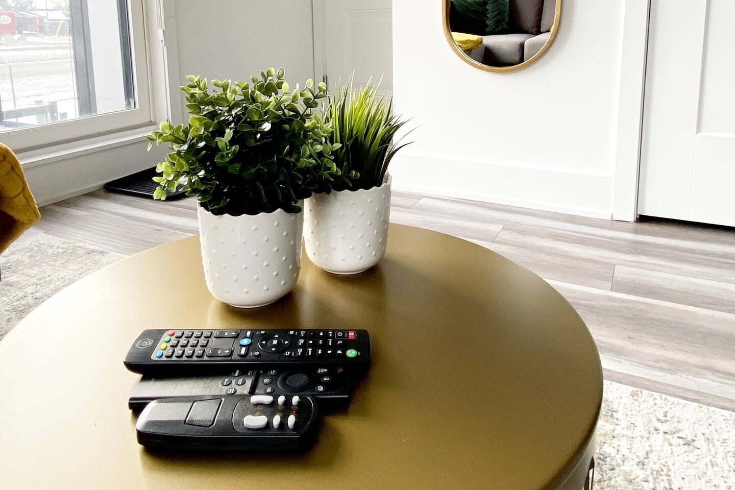 Coffee table setup with simple decor and remotes nearby, adding convenience to the living area for relaxed nights in.